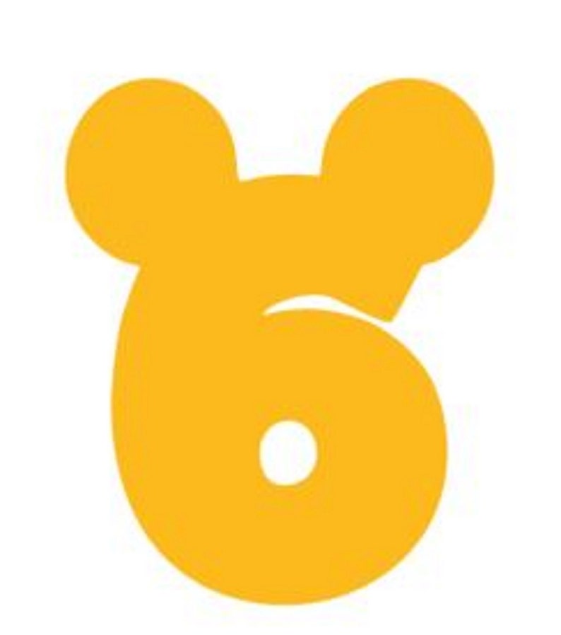 May include: A yellow number six with Mickey Mouse ears. The number is a whimsical design for a birthday party or other celebration.