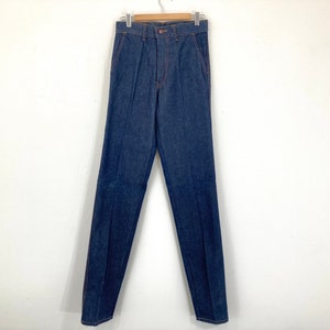May include: A pair of dark blue denim jeans with a straight leg fit.