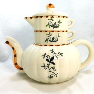 May include: A set of three ceramic mugs with a speckled, matte finish. The mugs are in shades of cream, light gray, and dark gray. Each mug has a simple, minimalist design, perfect for coffee or tea.