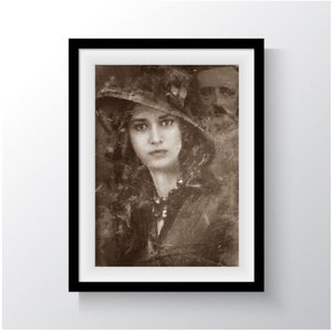 May include: A vintage sepia-toned photograph of a woman wearing a hat and a necklace. The woman is looking directly at the camera. The photo is slightly faded and has a textured look.