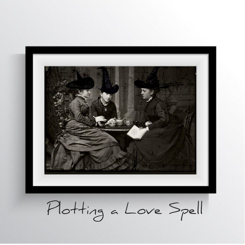 May include: Three women wearing black witch hats are sitting around a table, looking at a book. The image is in black and white and has a vintage feel. The text "Plotting a Love Spell" is written below the image.