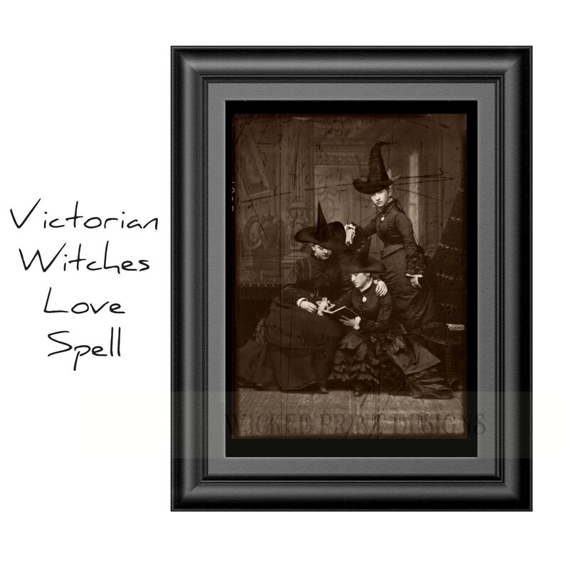 May include: A vintage sepia-toned photograph of three women dressed in Victorian-era clothing, wearing witch hats and holding a book. The women are sitting in a room with ornate wallpaper and a dark wooden floor. The image is framed in a black frame.