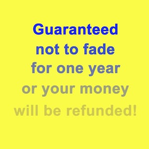 May include: A yellow background with blue and gray text that reads "Guaranteed not to fade for one year or your money will be refunded!"