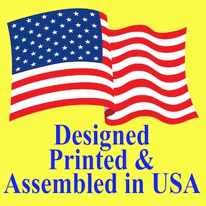 May include: An American flag waving in the wind with the text "Designed Printed & Assembled in USA" below it.