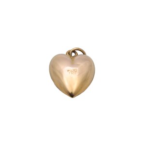 May include: A gold-colored heart-shaped pendant with a small loop at the top for a chain. The pendant has a smooth, polished surface and a subtle inscription on the front. The heart shape is rounded and symmetrical.