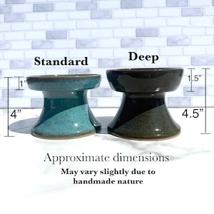 May include: Two ceramic bowls on pedestals. The left bowl is teal, labeled Standard, with a 1-inch depth and 4-inch height. The right bowl is dark green, labeled Deep, with a 1.5-inch depth and 4.5-inch height. Text reads Approximate dimensions.
