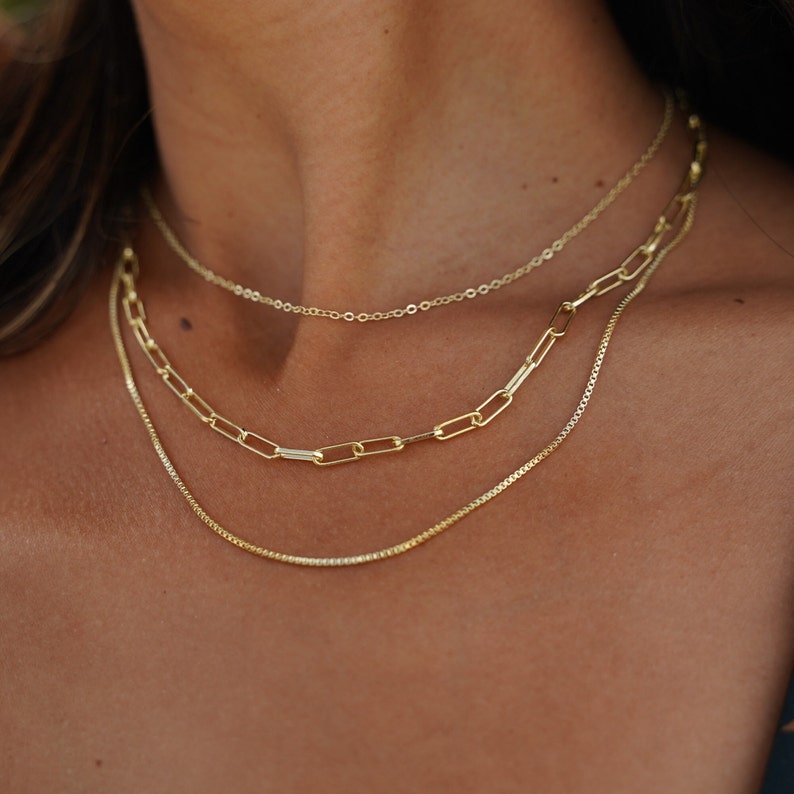 Wedding gold layered necklace set. Perfect for bridesmaid and bridal jewelry. Special occasion jewelry and necklace. Necklace is adjustable and comes with lobster clasps.  14K gold dainty chains triple strand. Each chain link varies in size.