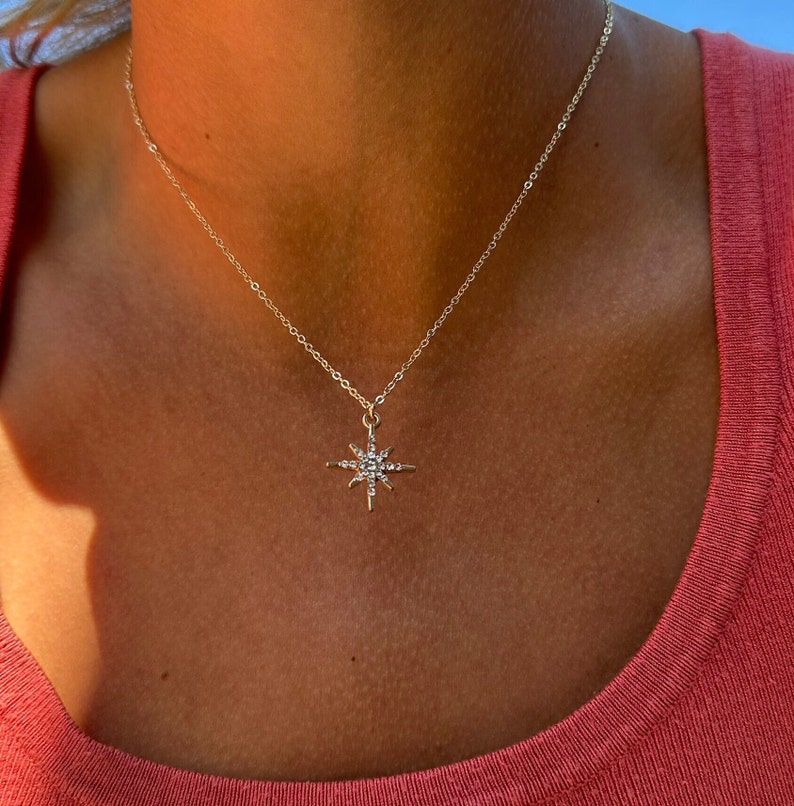 Here is an example of the gold North Star chain worn on its own. Each chain comes separately. This pendant is on a thin and dainty 14k cable chain. Perfect for additional layering and stacking.