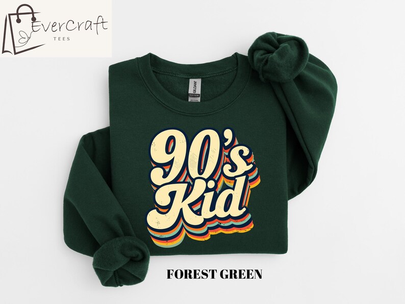 May include: Forest green sweatshirt with a retro-style graphic that says "90's Kid" in yellow and orange letters.