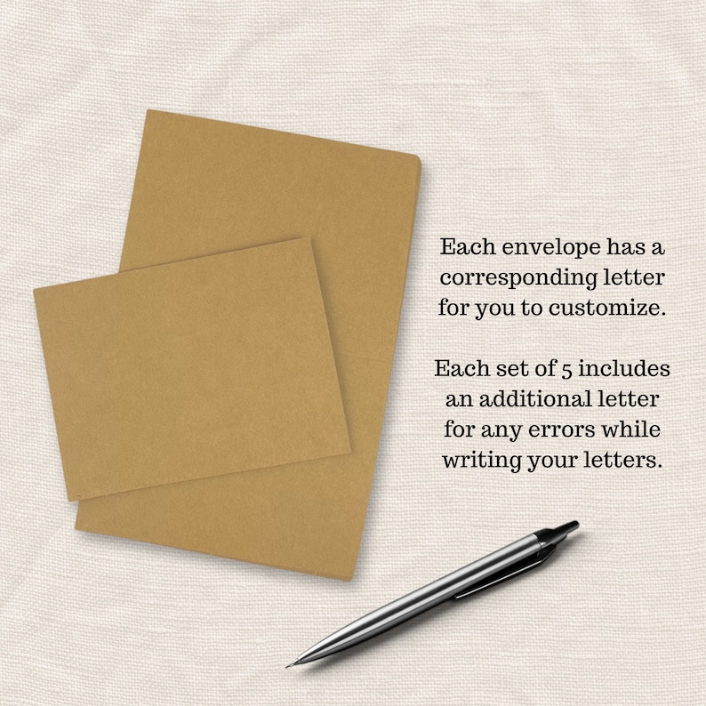 May include: Two brown envelopes stacked on top of each other on a white fabric surface. A silver pen is lying on the surface. The text on the image reads: "Each envelope has a corresponding letter for you to customize. Each set of 5 includes an additional letter for any errors while writing your letters."