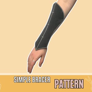 May include: A black bracer pattern is shown on an arm, with white stitching details. The text "SIMPLE BRACER PATTERN" is displayed on a yellow banner at the bottom of the image. The bracer is a dark grey colour.
