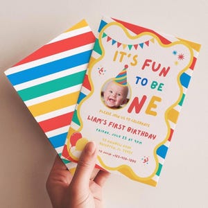 May include: A colorful birthday invitation with the text "IT'S FUN TO BE ONE" and a photo of a baby wearing a party hat. The invitation has a striped pattern on the back and includes event details.