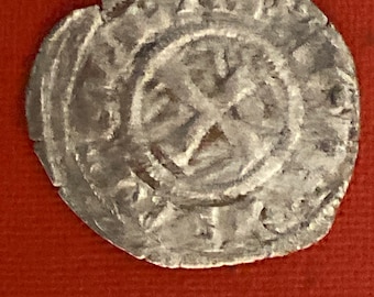 May include: A silver coin with a cross in the center and the inscription "REX" around the edge.