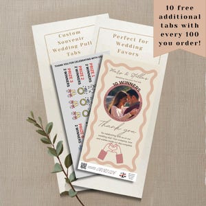 May include: Custom wedding pull tabs featuring a photo of a couple, the text Maro & Stella's Wedding Souvenir Pull Tab, 10 Winners, Thank you, and prize categories. The design includes a wavy border, heart-shaped hands, and a QR code at the bottom.