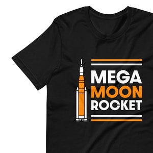 May include: Black t-shirt with a white outline of a rocket ship and the text "MEGA MOON ROCKET" in orange and white.