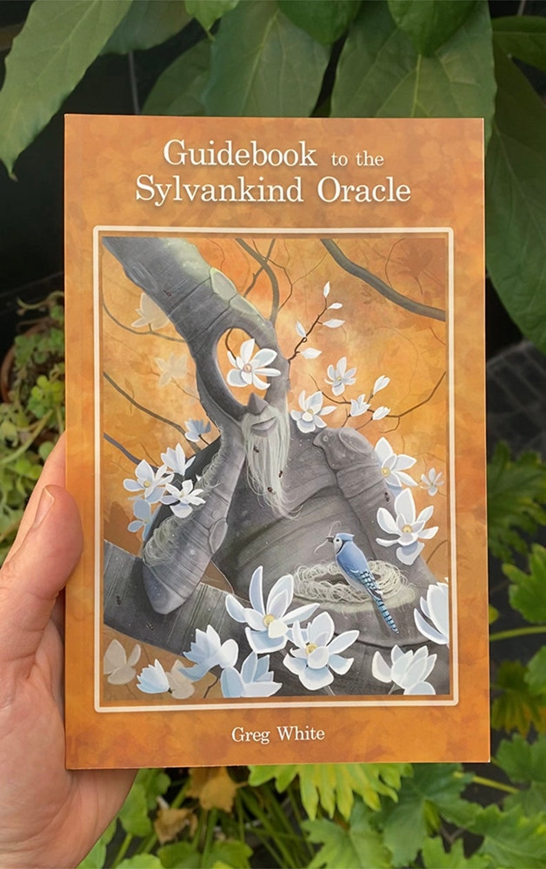 May include: Guidebook to the Sylvankind Oracle by Greg White. The cover features a painting of a tree with a face, white flowers, and a bluebird in a nest.