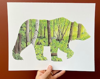 May include: A white paper print featuring a silhouette of a bear. The bear is filled with a watercolour painting of a woodland scene with green trees and leaves.