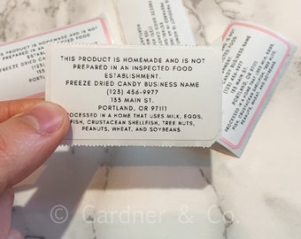 May include: A white label with black text that reads "This product is homemade and is not prepared in an inspected food establishment. Freeze Dried Candy Business Name (123) 456-9977 133 Main St. Portland, OR 97111 Processed in a home that uses milk, eggs, fish, crustacean shellfish, tree nuts, peanuts, wheat, and soybeans."