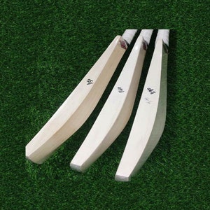 May include: Three wooden cricket bats with the numbers "116", "118", and "119" written on them.