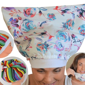 May include: A white floral patterned scrub cap with blue, purple, and red flowers. The cap has a white mesh band and is being held up by two hands. Additional caps with colorful stripes are also shown.