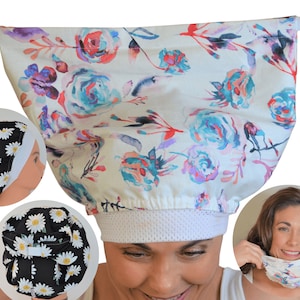 May include: A white shower cap with a floral pattern in shades of blue, purple, and red is held up by two hands. The cap has a white mesh band. Two smaller images show a black cap with white daisies.