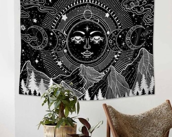 May include: Black and white tapestry featuring a stylized sun with a face and three crescent moons. The sun is surrounded by stars and rays of light. The background is a dark sky with clouds and mountains.