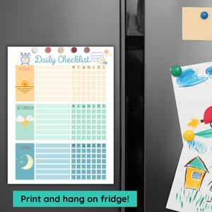 Daily routine chart for kids displayed on a refrigerator with magnets, morning afternoon evening sections shown