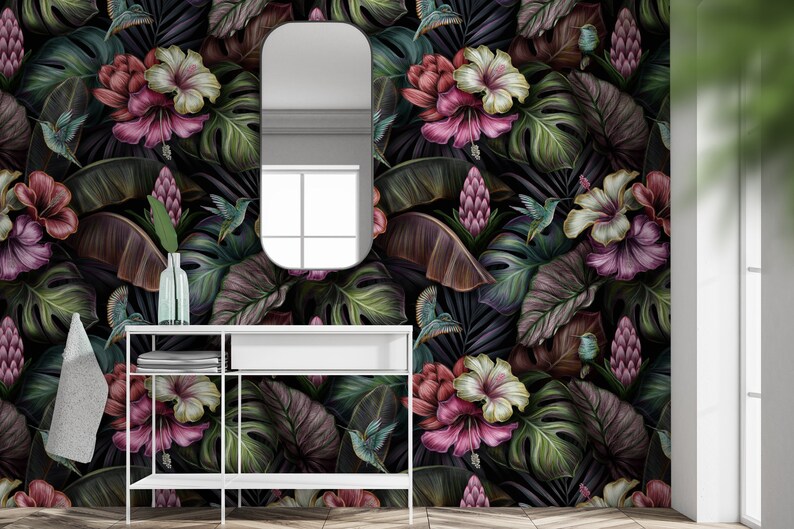 May include: Wallpaper featuring a dark tropical pattern with large green monstera leaves, pink and white hibiscus flowers, purple ginger blossoms, and small hummingbirds. The design is set against a black background, creating a dense botanical display.