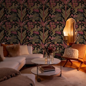 May include: Wallpaper featuring a repeating pattern of leopards, palm trees, and pink flowers on a black background. The room includes a white sofa with plush pillows, a round two-tier coffee table, a wooden chair, and an irregular wall mirror.