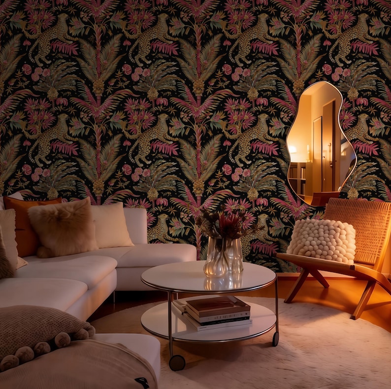 May include: Wallpaper featuring a repeating pattern of leopards, palm trees, and pink flowers on a black background. The room includes a white sofa with plush pillows, a round two-tier coffee table, a wooden chair, and an irregular wall mirror.