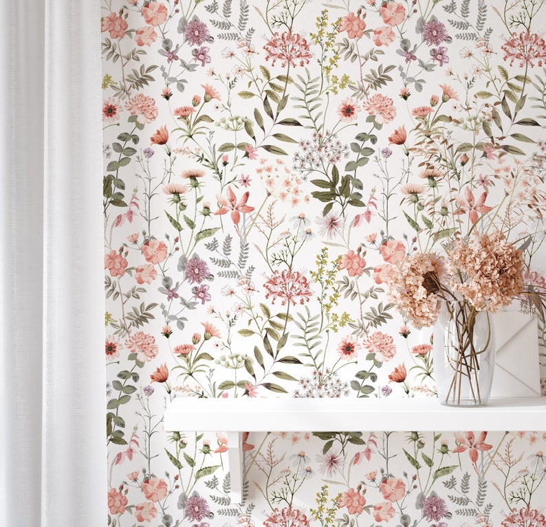 May include: A white background with a floral pattern featuring pink, purple, and green flowers. The flowers are arranged in a random pattern and are surrounded by green leaves.