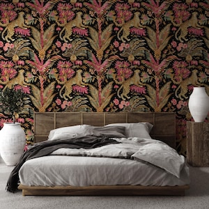 May include: A bedroom featuring wallpaper with a black background and a repeating pattern of gold leopards, pink palm leaves, and tropical flowers. The bed has a wooden frame, a cane headboard, and gray bedding. Two large white vases sit on either side.