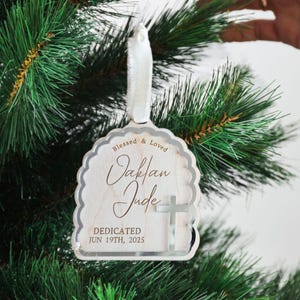 Wooden dedication ornament with silver cross design, custom name and event date.