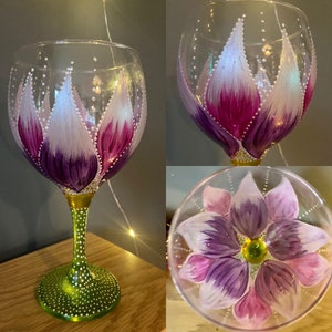 Pink and purple petals with green stem. Stunning hand painted gin balloon. Quirky and unique. Ideal gift