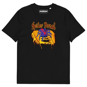 May include: Black t-shirt featuring a colorful graphic of a blue spider on a slice of bread with dripping yellow cheese. The text "Spider Bread" is above the bread. The shirt has a crew neck and short sleeves.