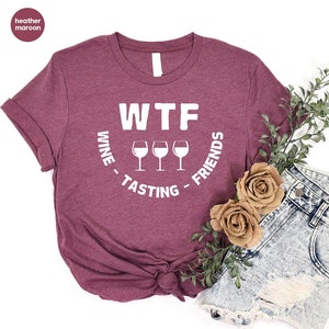 May include: A heather maroon t-shirt with the text "WTF Wine - Tasting - Friends" in white lettering and three wine glass icons.
