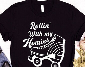 May include: Black t-shirt with white text that reads "Rollin' With my Homies" and a white roller skate graphic.