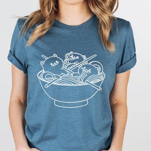 a woman wearing a t - shirt with a bowl of noodles on it