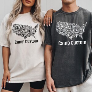 A man and a woman wearing matching t-shirts with a graphic design of the United States.