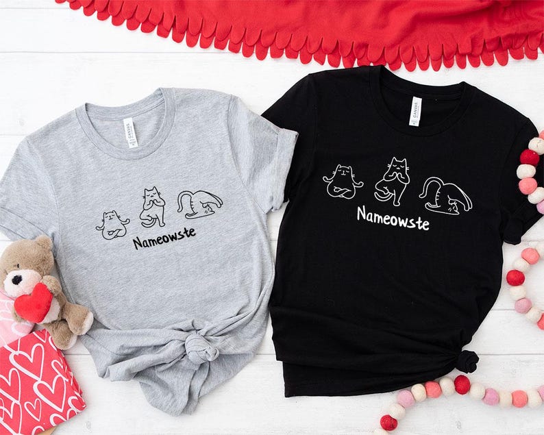 two t - shirts and a teddy bear on a table