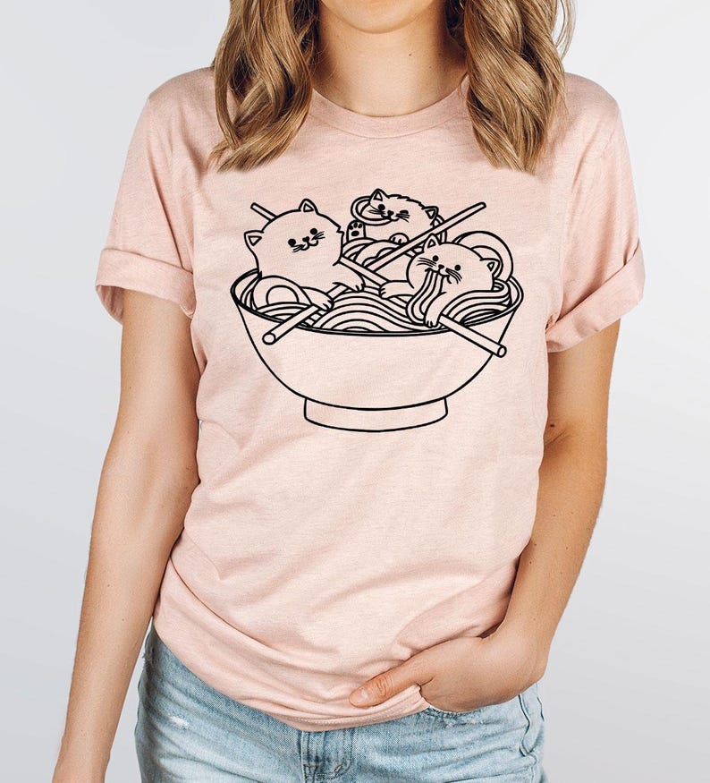 a woman wearing a t - shirt with a picture of a bowl of noodles