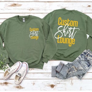 a pair of sweatshirts sitting on top of a wooden floor