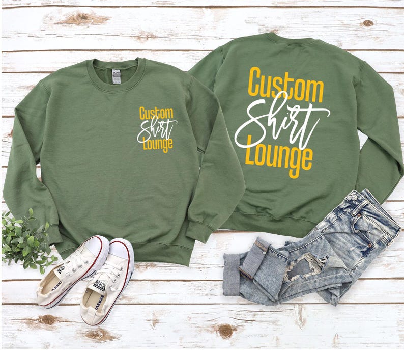 a pair of sweatshirts sitting on top of a wooden floor