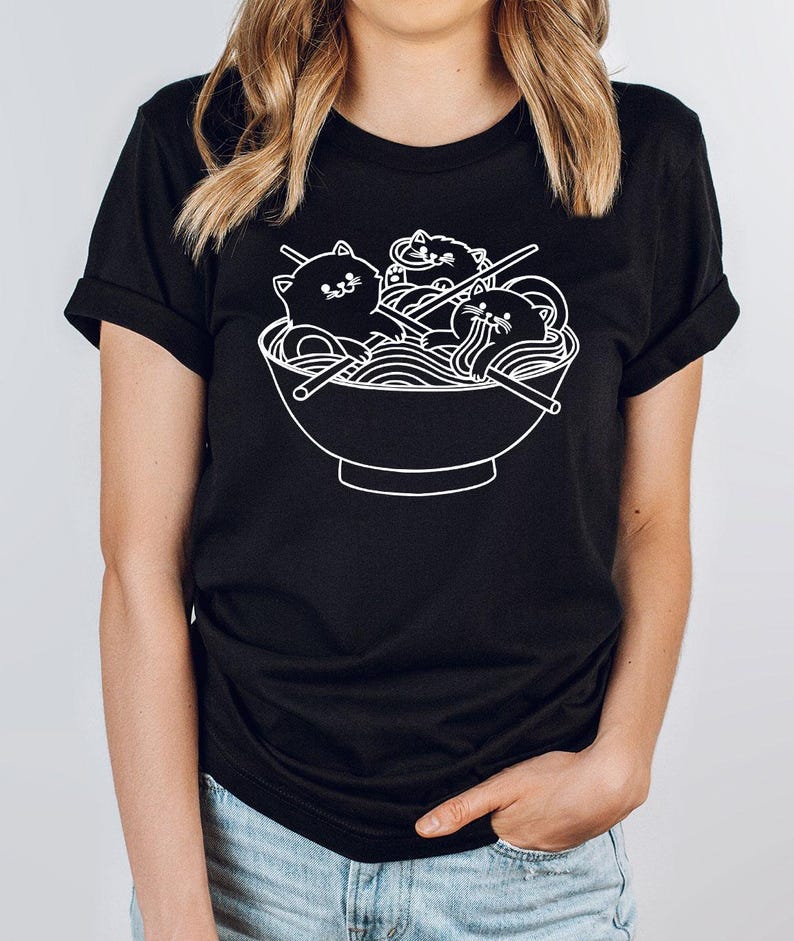 a woman wearing a black tshirt with a bowl of noodles on it