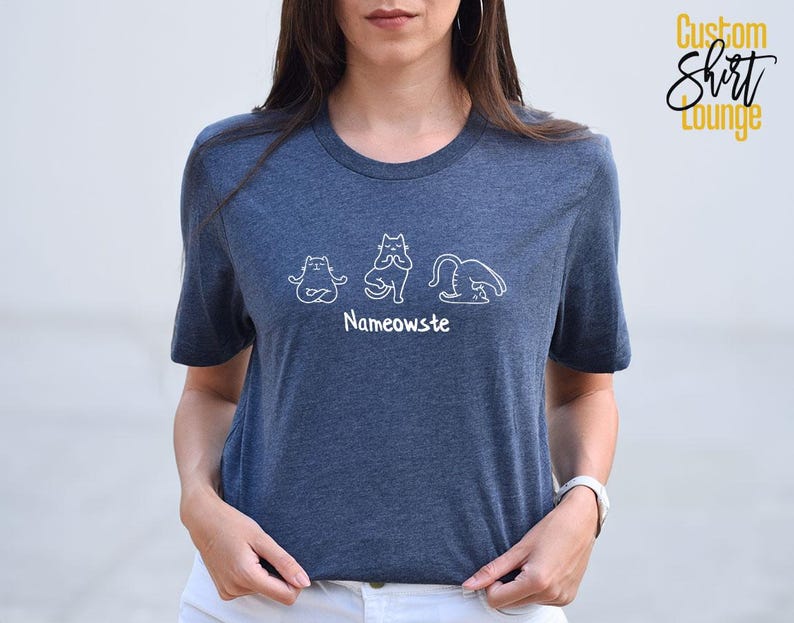 a woman wearing a blue t - shirt with the name namonosuit on it