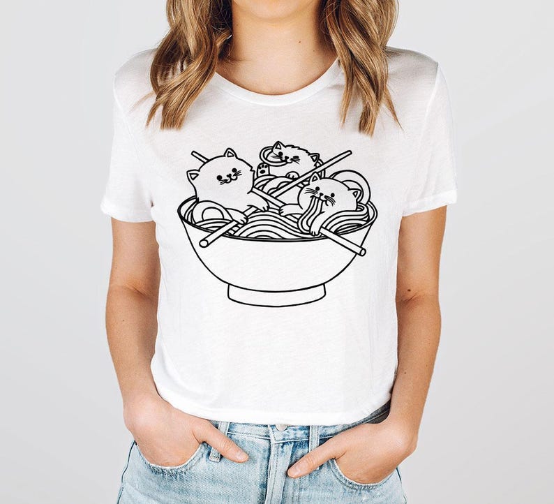 a woman wearing a t - shirt with a picture of a bowl of noodles