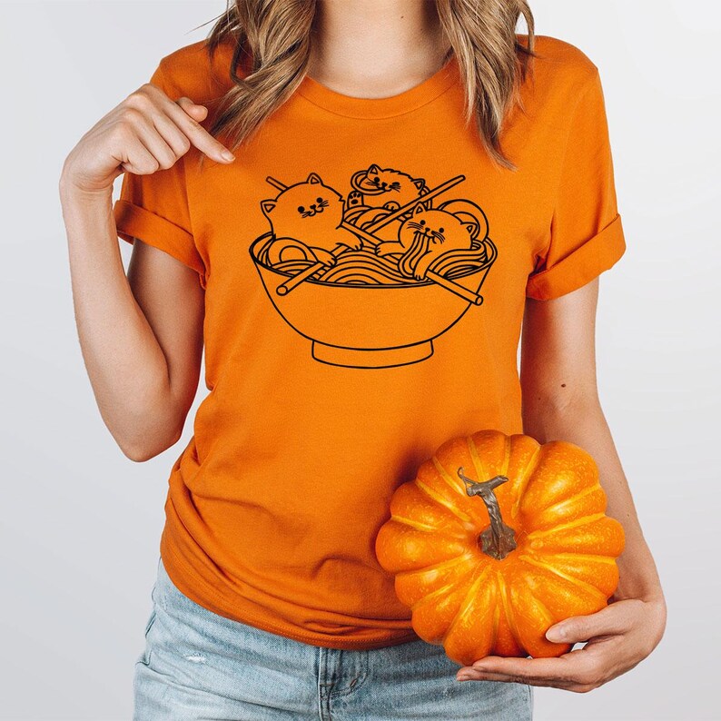 a woman holding a pumpkin and a bowl of noodles