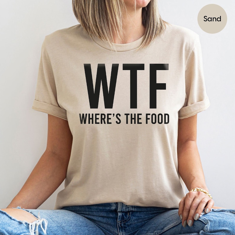 a woman wearing a t - shirt that says wtf where's the food
