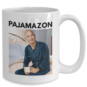 May include: White ceramic mug with a black graphic of a man in pajamas holding a cup. The text "PAJAMAZON" is printed in black above the graphic.
