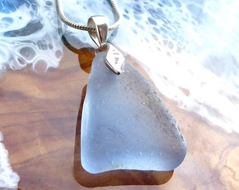 Pendant with light blue sea glass and leaf-shaped silver loop